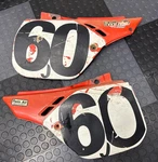 Honda CR125 CR250 CR500 1987 1990 Genuine Side Covers, # 83510 / 83610-KS6-7010. Fixed Price $75.00.