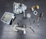 Lot 143-1, 1973-1974 Honda ATC70 Carburetor Assembly Intake. Fixed Price $55.00.
