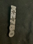 Kawasaki 80-82 KZ750 Side Cover Emblem Nos 56018-1201 Black/ Gold. Fixed Price $50.00.